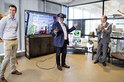 Philip Dalidakis, Minister for Small Business, Innovation and Trade, Government of Victoria, inaugurates Cognizant’s new Collaboratory in Melbourne by cutting the digital “ribbon” with a Virtual Reality light sabre.