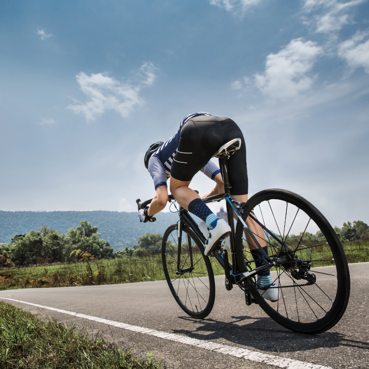 Man riding bicycle outside. 